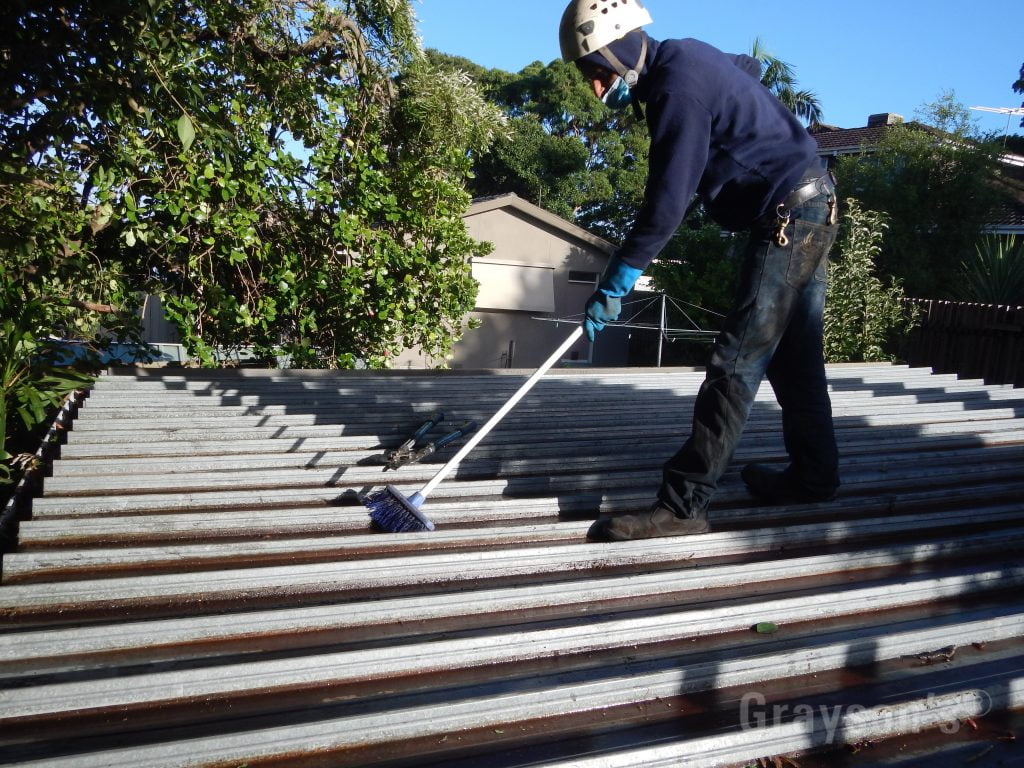 Sweeping a flat roof as part of our gutter cleaner service!