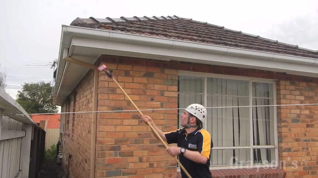 Grayson demonstrating a home-made Gutter Cleaning Inspection Cam