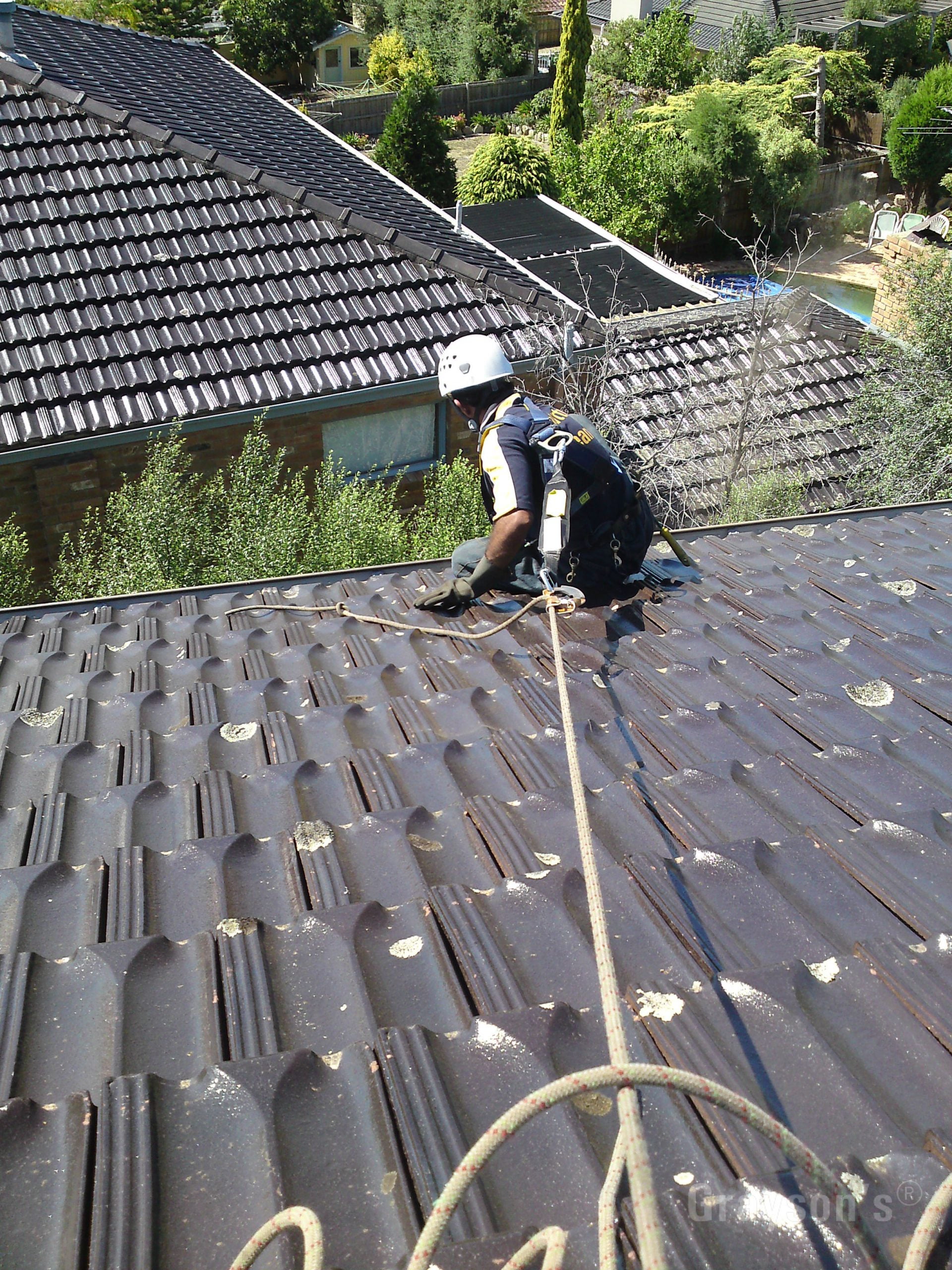 gutter cleaning with rope and harness