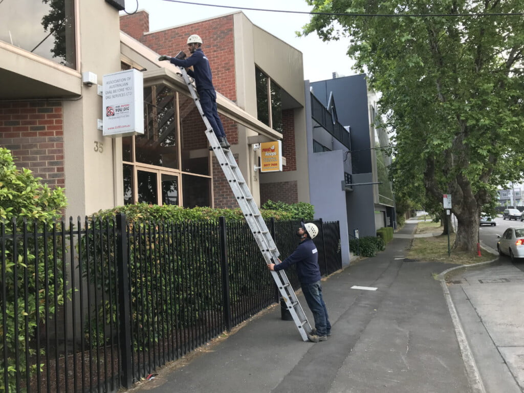 Cleaning the gutters on a small office building