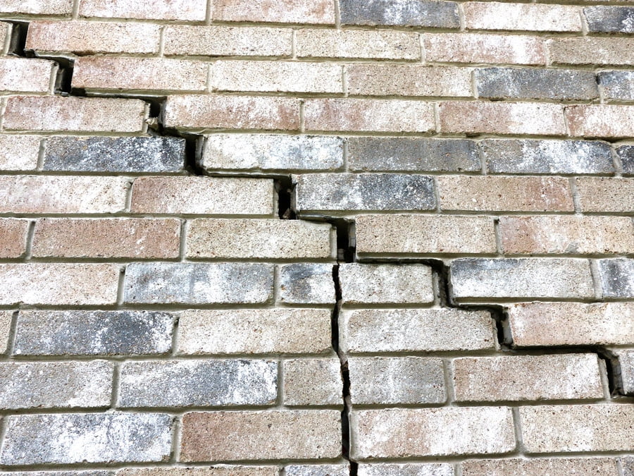 External brick wall showing cracks due to blocked downpipes