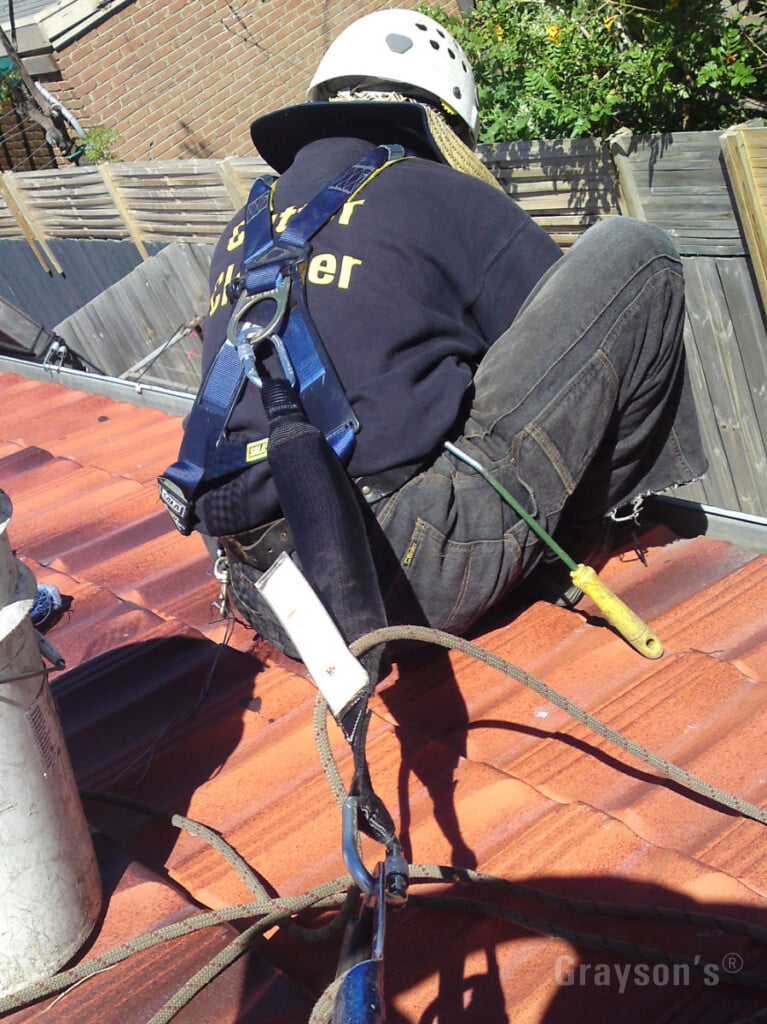 Grayson's cleaning gutters with proper safety equipment